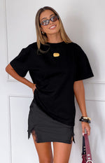 Fitted black satin mini skirt with a side slit and delicate black lace trim