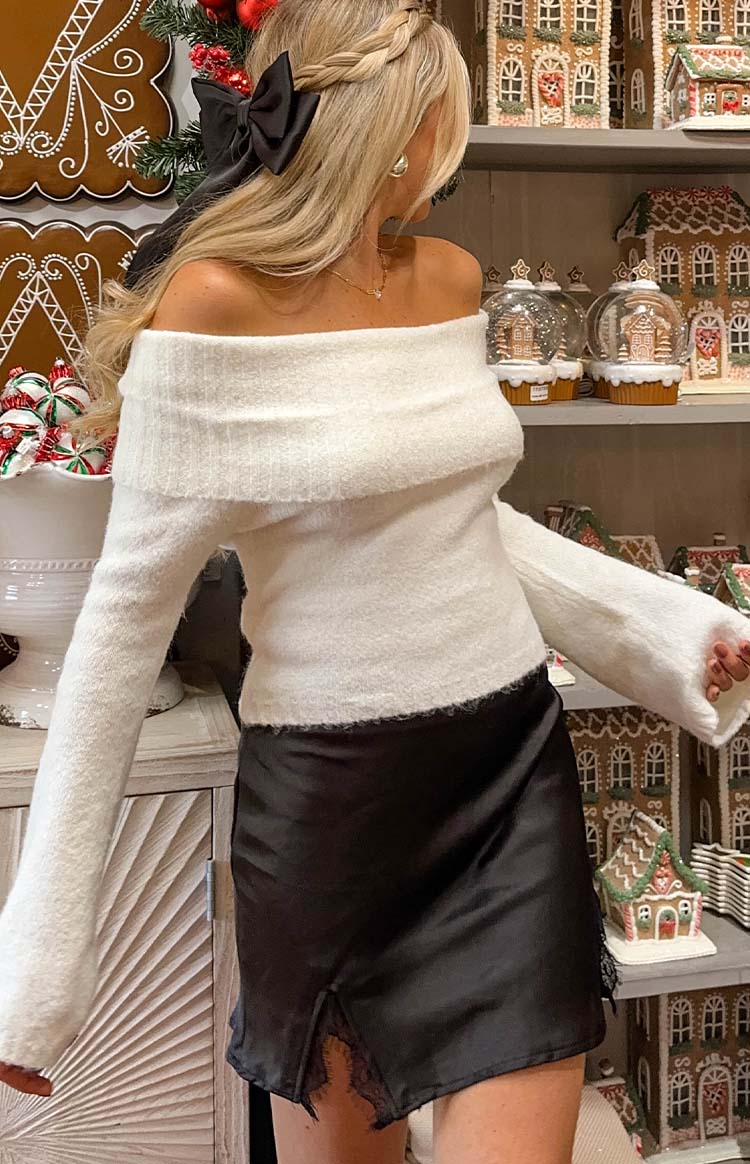 Black shiny mini skirt with a side split revealing black lace trim