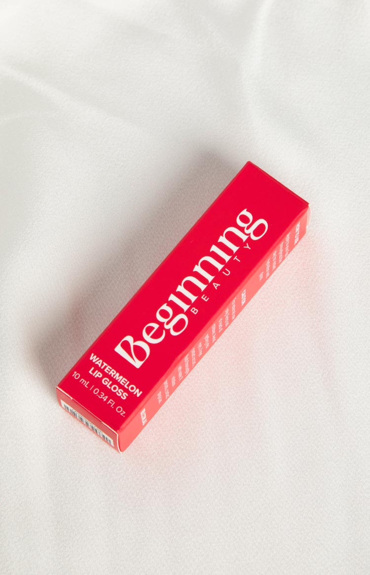 Red rectangular lip gloss box with 'Beginning Beauty' and 'Watermelon Lip Gloss' in white text