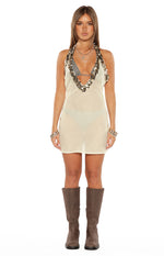 Sheer white mini dress with a relaxed fit, deep V-neckline, and sequin-trimmed halter straps