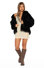 White mini dress with a sequin-trimmed halter neckline and subtle textured fabric