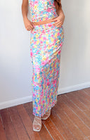 Full length view of the multi floral bodycon maxi skirt with a fitted silhouette and lettuce edge hem