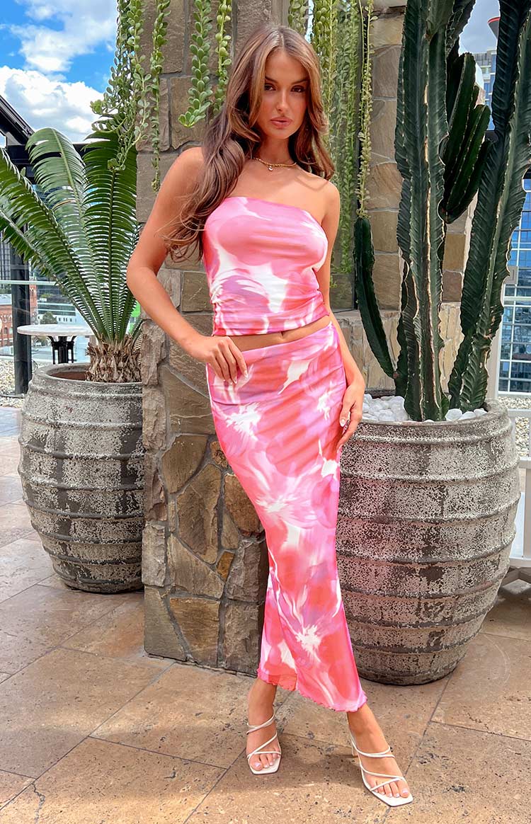 Front view of a pink floral print mesh maxi skirt, fitted through the hips and flowing to the ankles