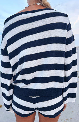 Rear view of the navy and white striped knit sweater, showing the wide boat neckline, long sleeves, and textured knit