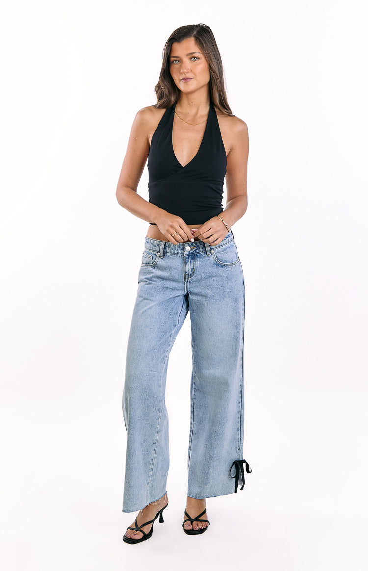 Beginning Boutique Willabelle Light Wash Denim Bow Hem Low Rise Jeans light wash wide leg jeans with black bow detail at the hem