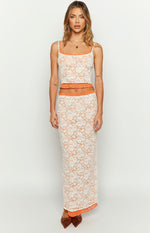 Front view of the white floral lace tank top with orange contrast trim, thin spaghetti straps, and a cropped hem