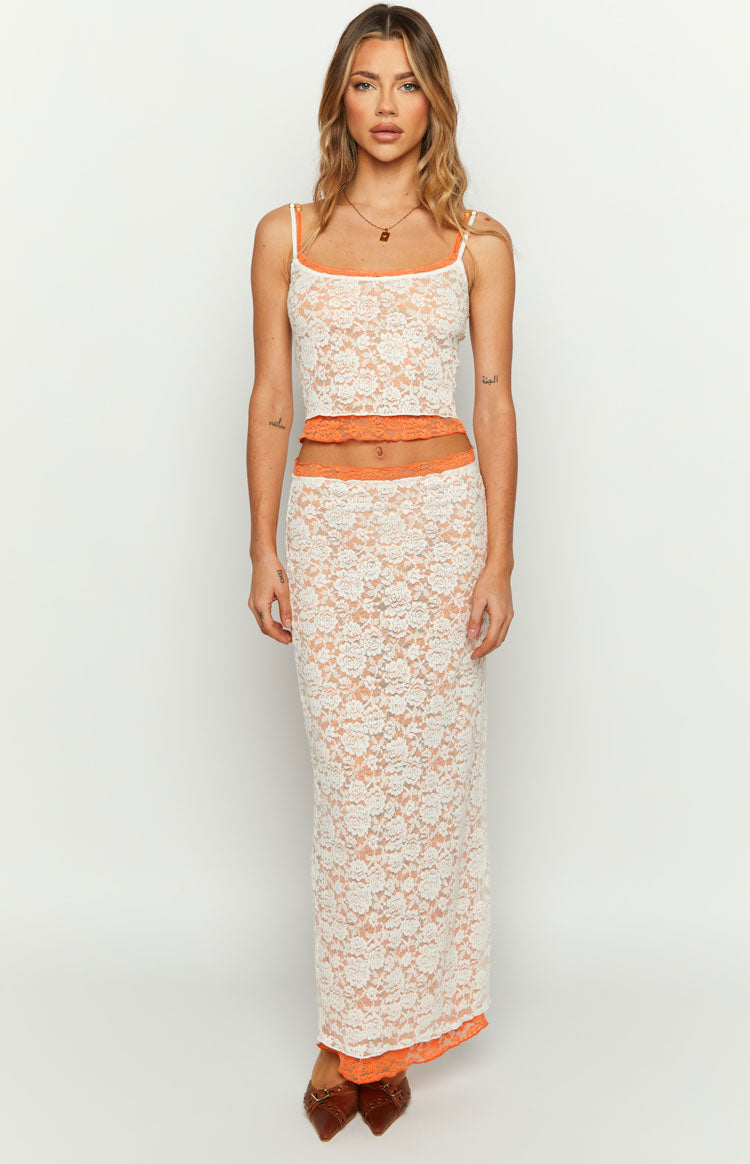 Front view of the white floral lace tank top with orange contrast trim, thin spaghetti straps, and a cropped hem