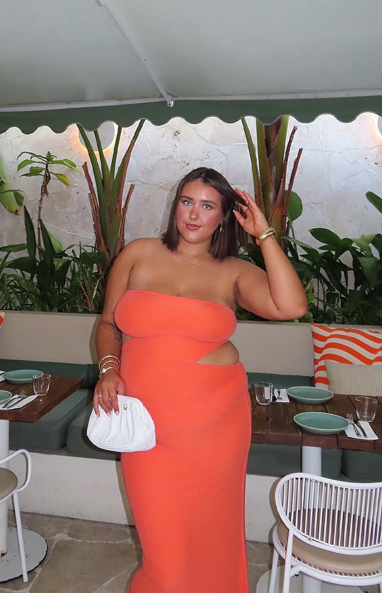 Orange strapless bodycon maxi dress with side cutouts at the waist