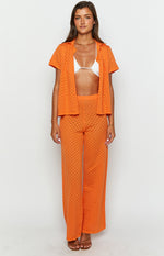 Orange open knit wide-leg pants with a diamond pattern and high waist