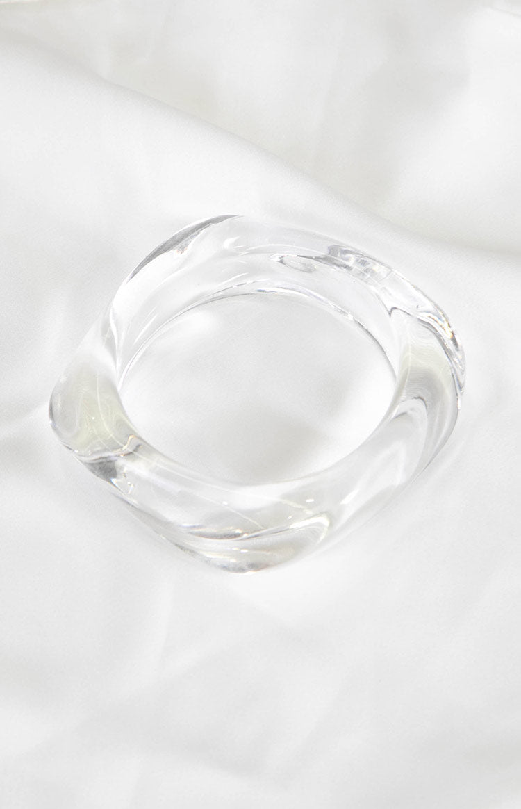Thick clear resin bangle with a soft, wavy square shape