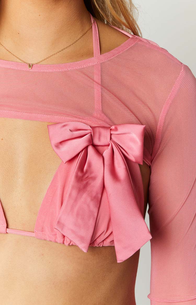 Close-up of the large pink satin bow detail on the back of the sheer mesh bolero