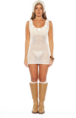 Front view of a white open knit crochet mini dress with floral appliques on the scoop neckline