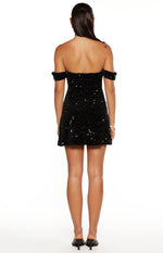 Rear view of a black velvet sequin off-the-shoulder mini dress with a fitted bodice and A-line skirt