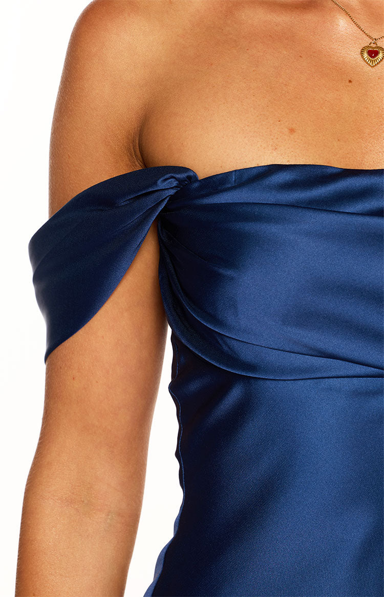 Close-up of the navy satin off-shoulder dress with twisted sleeve detail and draped bust