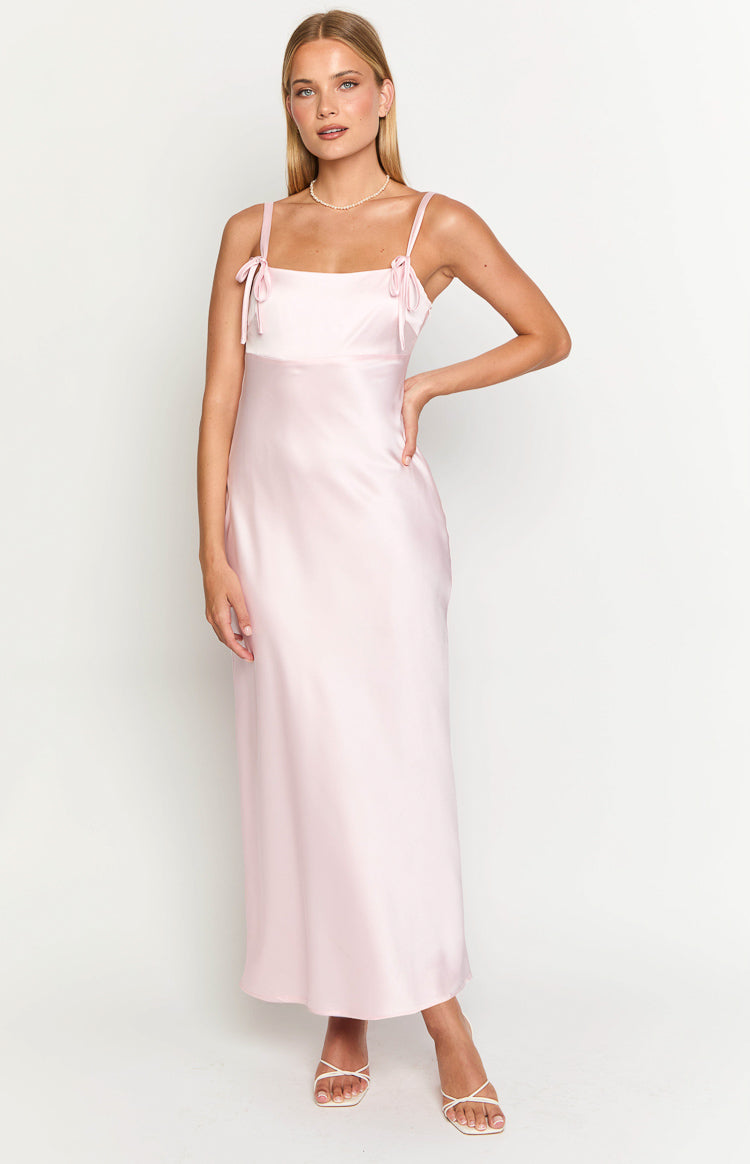 Front view of a light pink satin maxi dress with a square neckline and tie-detail spaghetti straps