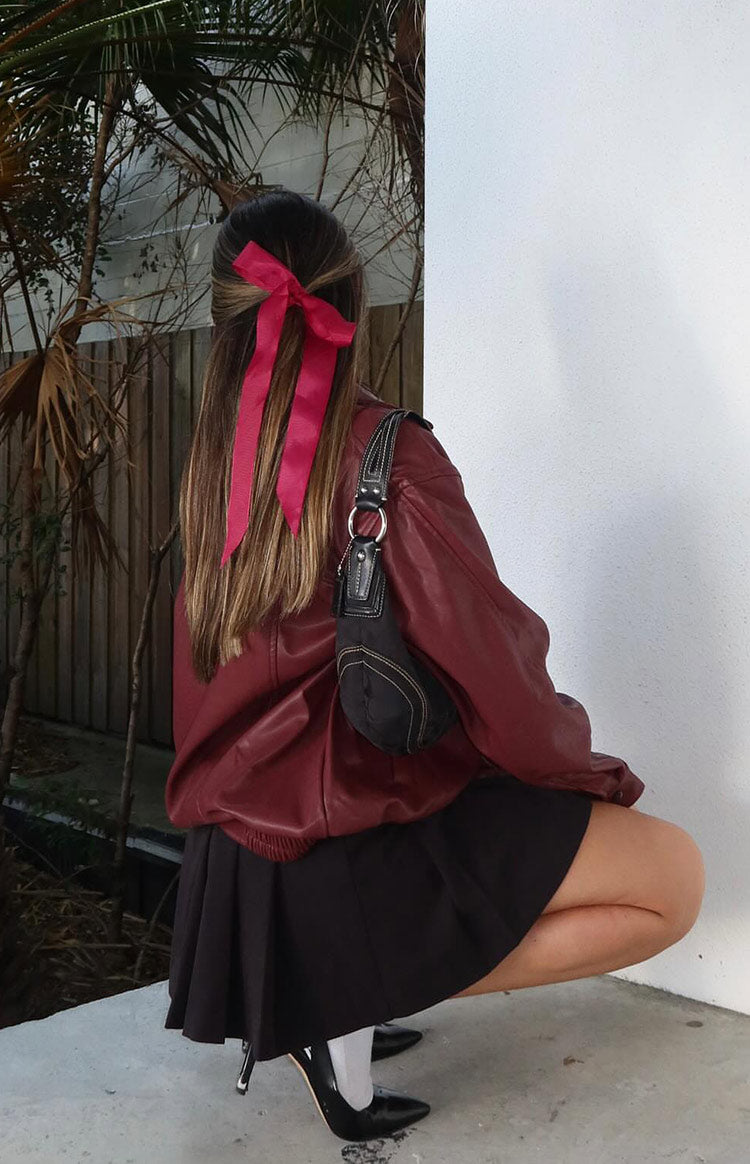 Rear and side view of a deep red PU bomber jacket with a relaxed silhouette and ribbed hem