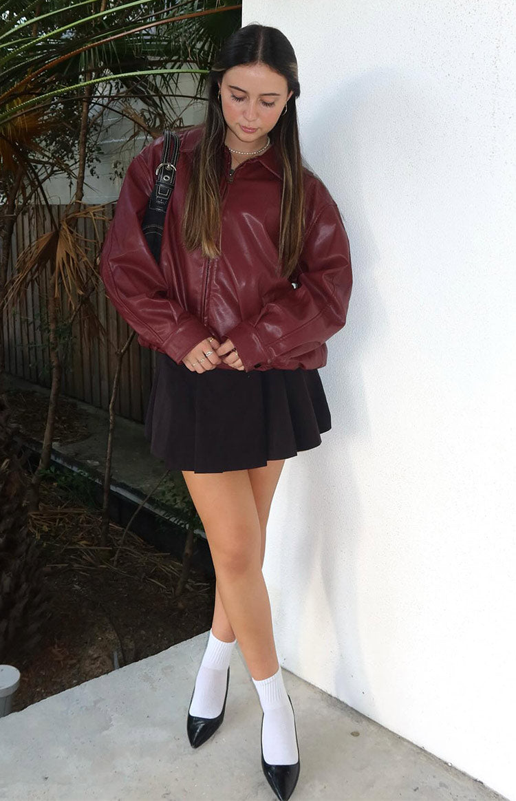 Front view of a red PU bomber jacket with an oversized fit, collared neckline, and gathered hem and cuffs