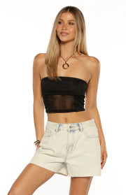 Light blue acid wash denim shorts with a relaxed fit, raw frayed hem, and front pockets