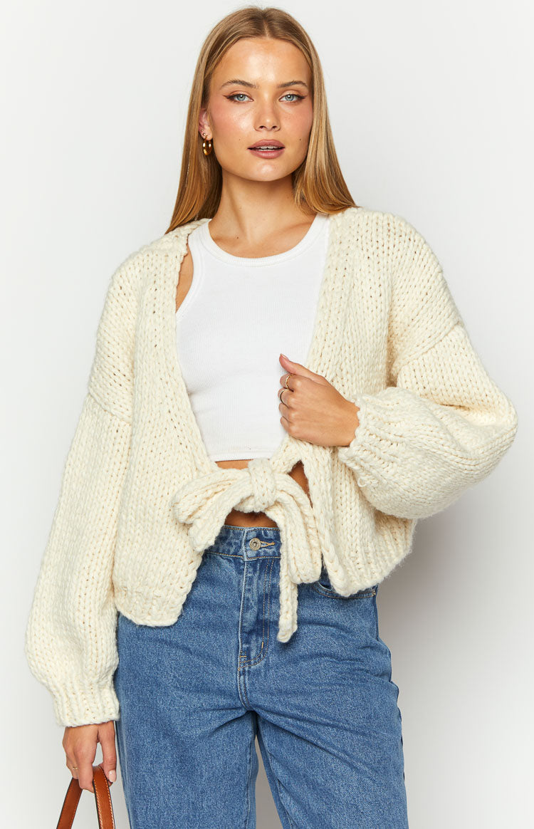 Cream chunky knit cardigan with a tie-up front and long voluminous sleeves