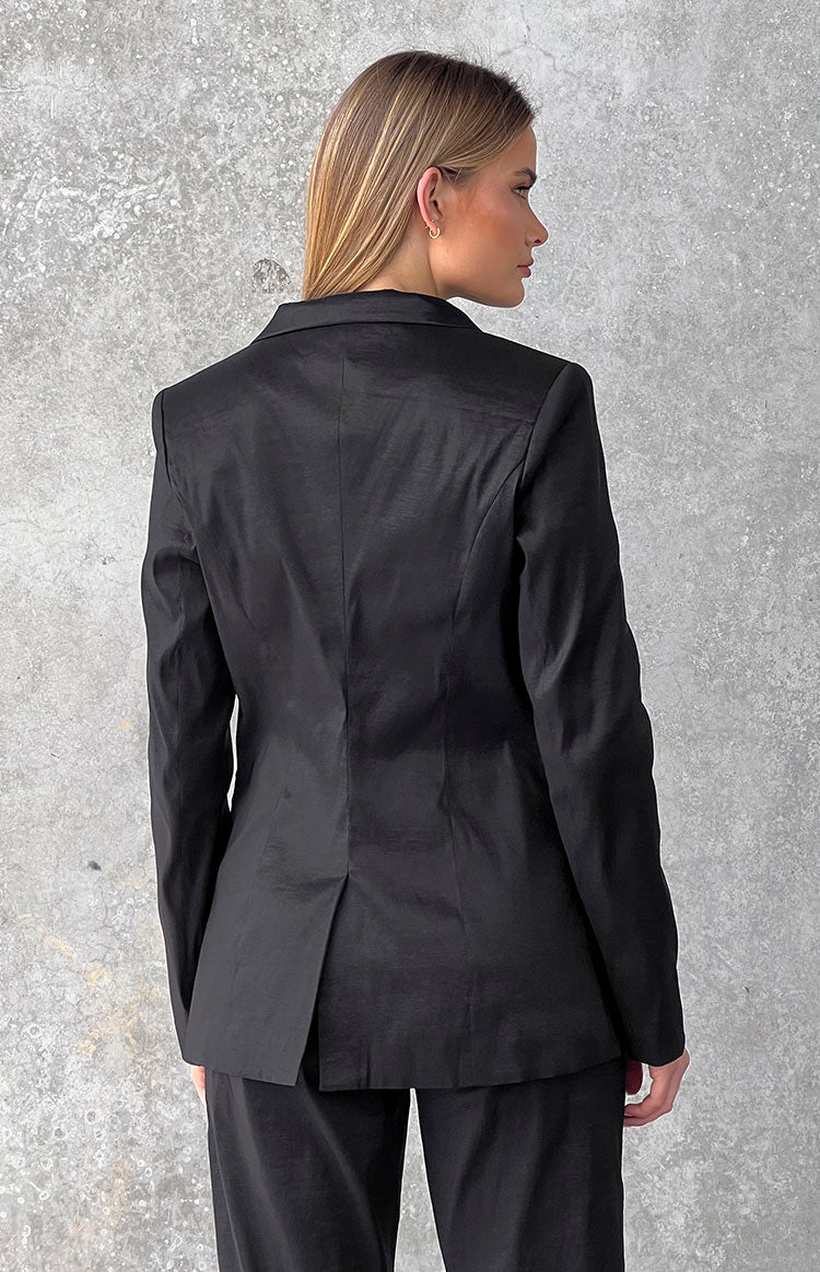 Side and back view of a black blazer with structured shoulders and a single vent