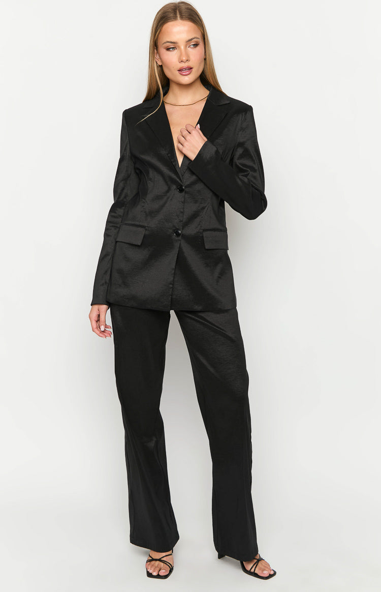 Black long sleeve blazer with notched lapels, two buttons, flap pockets, and a subtle crinkled texture