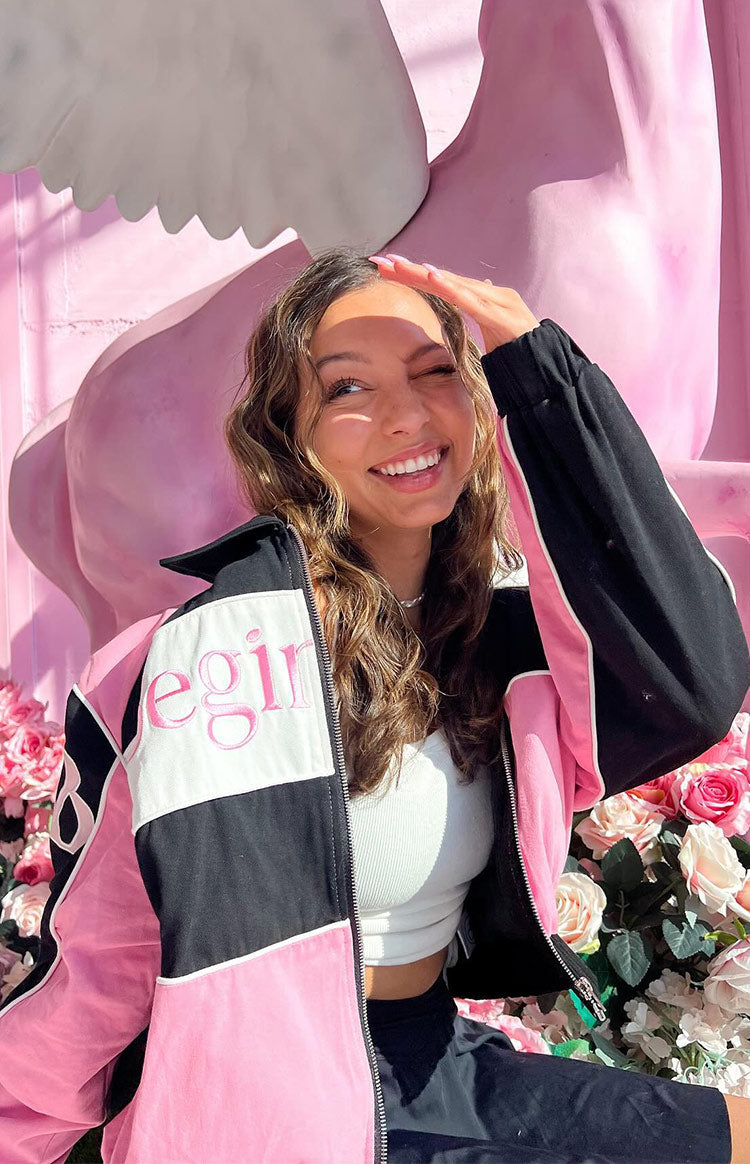Close-up of the pink, black, and white colour block bomber jacket with pink 'egin' embroidery, open front