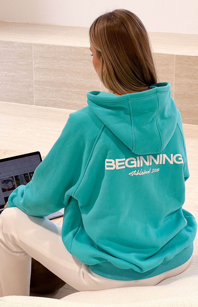 Beginning Boutique Beginning Teal Established Bubble Hoodie teal oversized hoodie with white "BEGINNING established 2008" print on the back and ribbed hem