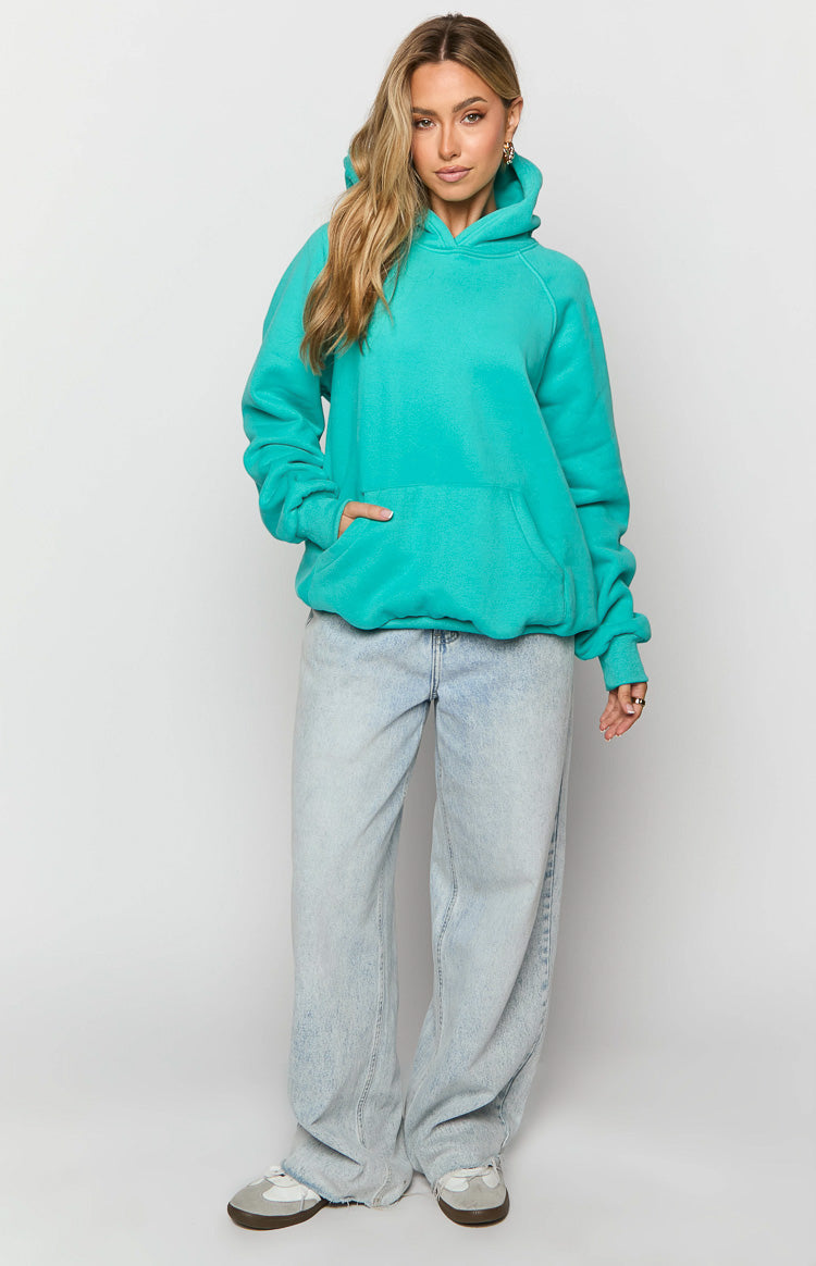 Front view of an oversized teal fleece hoodie with a large kangaroo pocket and raglan sleeves