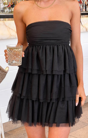 Black strapless mini dress with a ruched bodice and a voluminous tiered tulle skirt