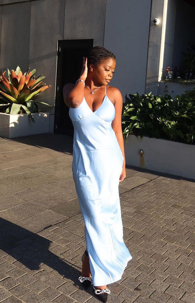 Light blue satin maxi dress with a V-neckline, thin spaghetti straps, and a flowy silhouette