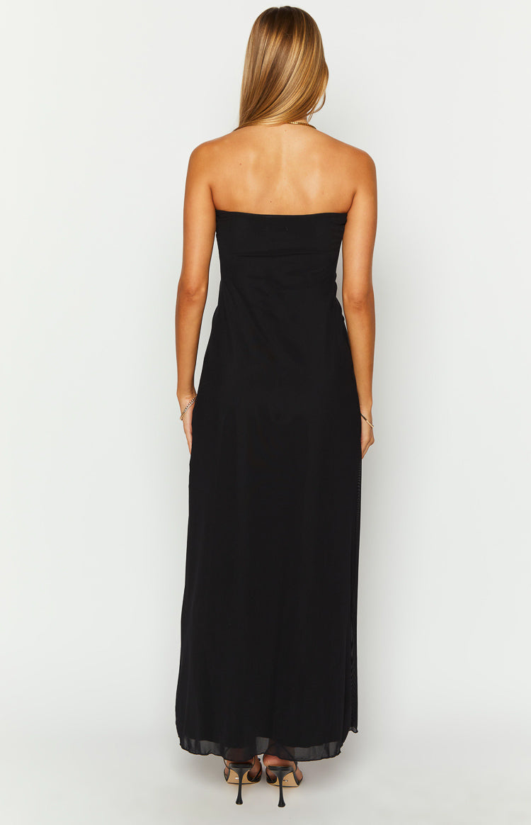 Back view of a black strapless maxi dress featuring a straight neckline and a long flowing skirt with a subtle sheer hem
