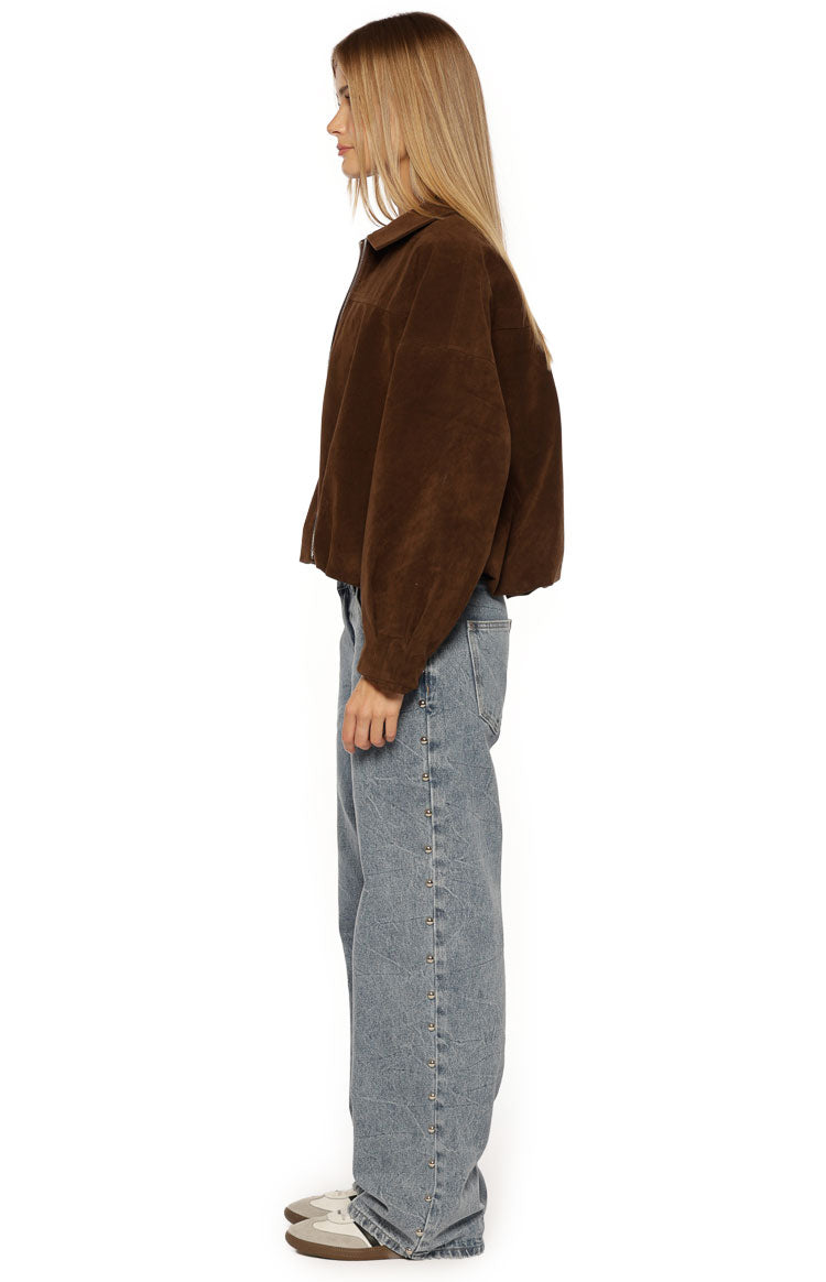 Side view of a brown suedette bomber jacket with a relaxed, cropped fit and voluminous sleeves