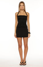 Black lace halter neck top with a fitted silhouette and a scalloped neckline