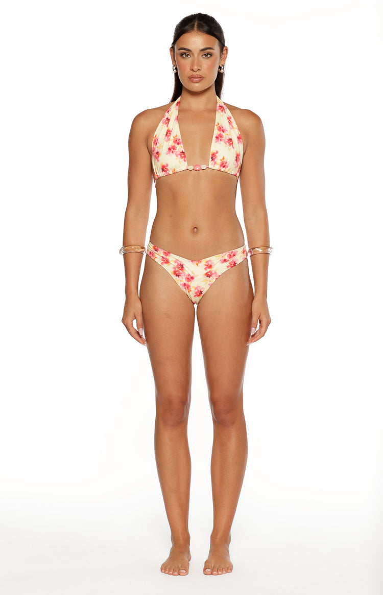 Front view of yellow and pink floral print bikini bottoms with a V-front waist