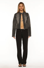 Front view of a cropped washed black denim biker jacket with a band collar and exposed zipper
