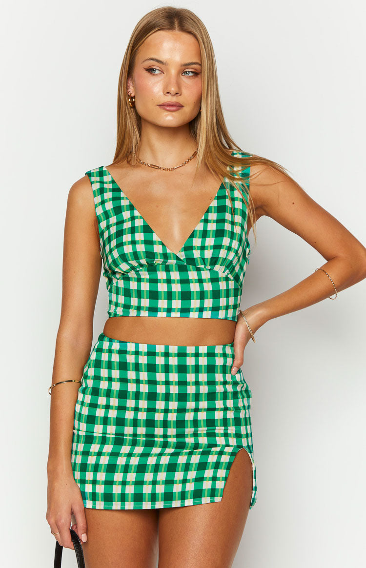 Front view of a green and cream check crop top with a deep V-neckline and wide shoulder straps