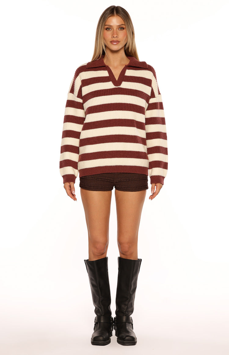 Front view of a burgundy and cream striped knit polo sweater with a relaxed fit and long sleeves