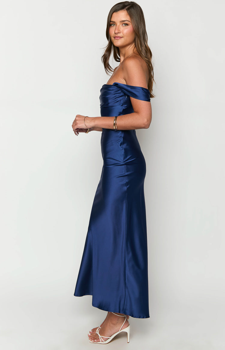 Side view of a navy satin off-shoulder maxi dress with a fitted bodice and flowing skirt