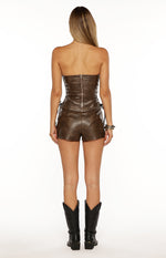 Rear view of fitted vintage brown PU shorts with side lace-up detail
