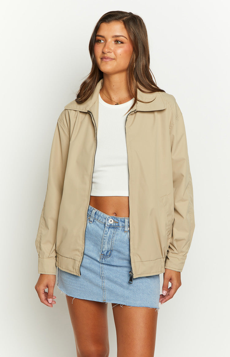 Front view of a fawn windbreaker bomber jacket, partially unzipped, showing the classic collar and relaxed fit
