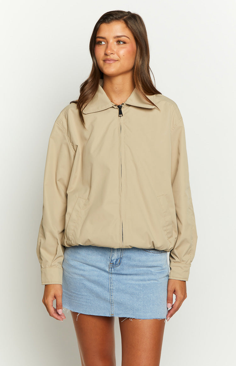 Fawn windbreaker bomber jacket with a pointed collar, full black zip front, and elasticated hem