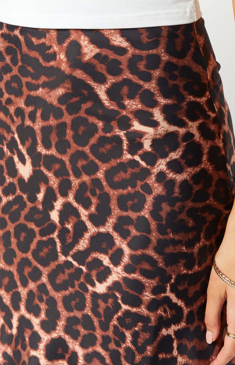 Close-up of the brown and black leopard print fabric of the maxi skirt, highlighting the smooth texture and top edge