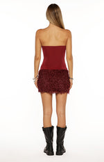 Rear view of the burgundy strapless mini dress showing the smooth fitted bodice and fluffy fur mini skirt