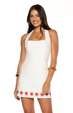 White mini dress with a square neckline, halter straps, and red sun embroidery along the hem