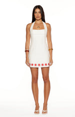 White halter mini dress with a square neckline and red sun embroidery along the hem