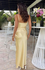 Rear view of the light yellow satin maxi dress with a low scoop back and thin spaghetti straps