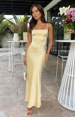 Front view of the yellow satin maxi dress with a square neckline, thin straps, and a fitted bodice with visible seam details