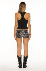 Rear view of the black wash tank top showing the racerback design and a slightly cropped hem