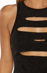 Close-up of the ribbed black wash tank top showing the horizontal cutouts and distressed fabric texture