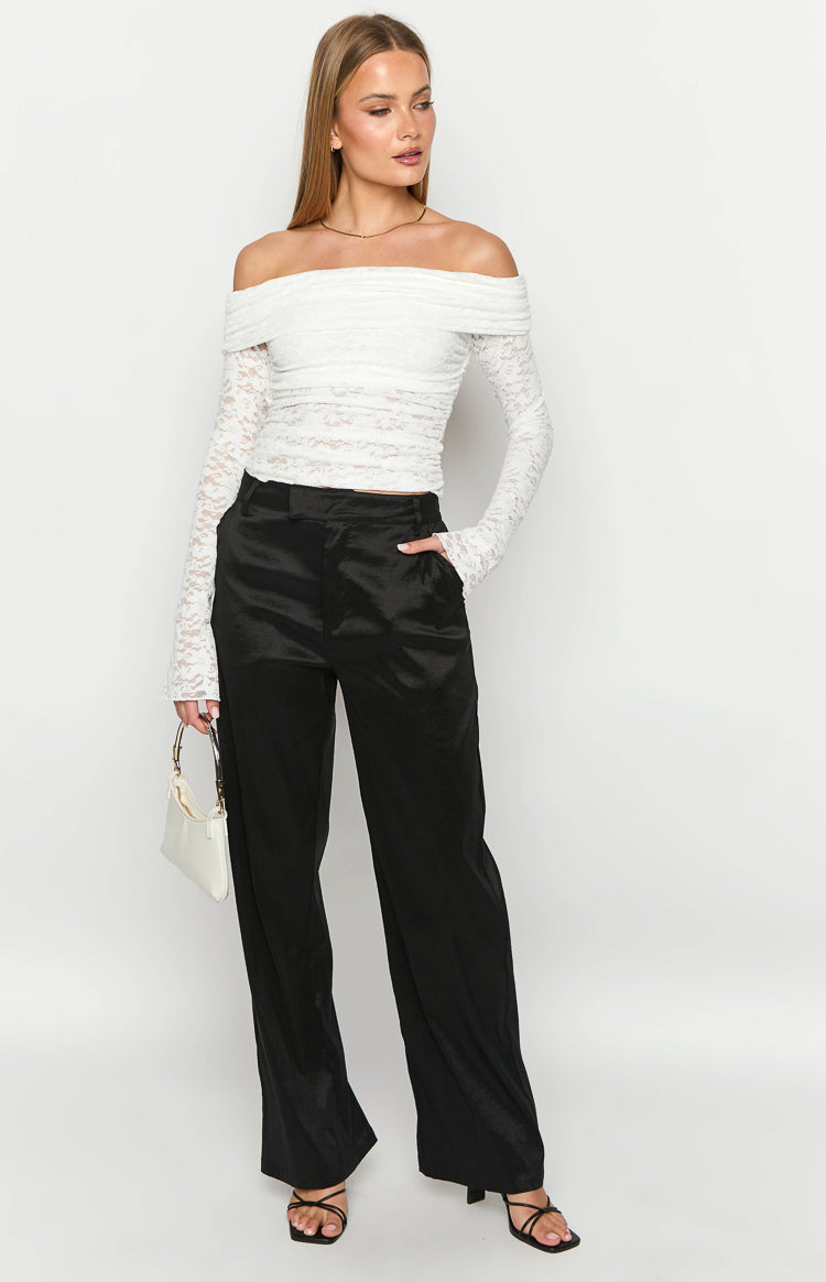 Full length view of black wide-leg pants with a relaxed fit and subtle satin sheen